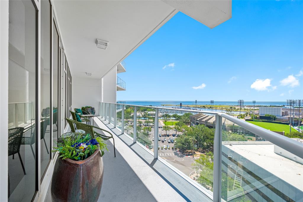 An aerial view of a modern high-rise apartment building surrounded by city streets and buildings — 175 1ST STREET S UNIT 1204, ST PETERSBURG, FL