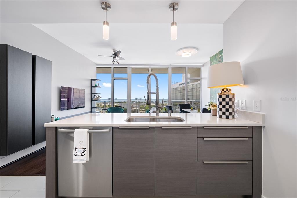 An aerial view shows a tall residential skyscraper next to a marina and airport runway — 175 1ST STREET S UNIT 1204, ST PETERSBURG, FL