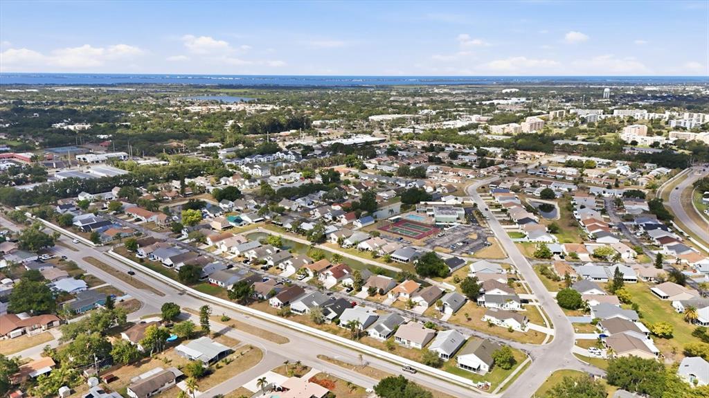 An aerial view shows a suburban street with single-story houses, driveways, and landscaped front yards — 4006 W 37TH STREET COURT W, BRADENTON, FL