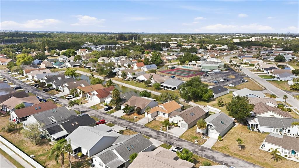 An aerial view of a single-story house with a concrete driveway and landscaped front yard — 4006 W 37TH STREET COURT W, BRADENTON, FL