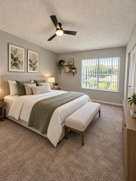 An empty bedroom features beige carpeting, light gray walls, a ceiling fan, and two windows — 888 FRANKLIN CIRCLE, PALM HARBOR, FL