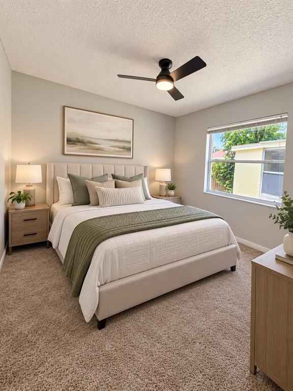 A bedroom with beige carpet, a ceiling fan, a window, and white louvered closet doors — 888 FRANKLIN CIRCLE, PALM HARBOR, FL