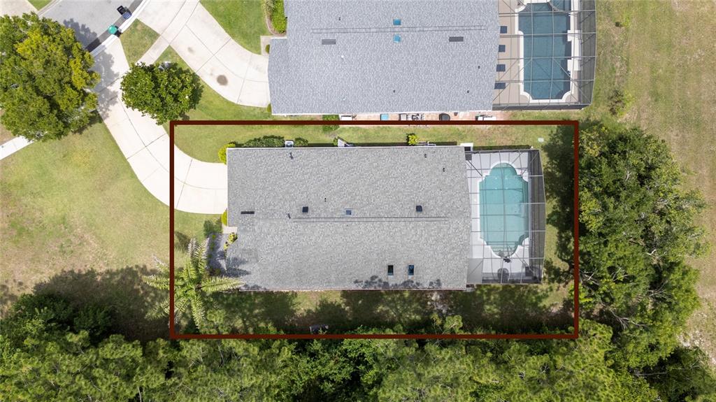 A single-story suburban house with a two-car garage, manicured shrubs, and a palm tree — 10966 ELIOTTI STREET, ORLANDO, FL