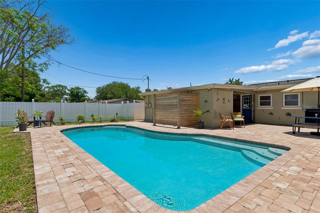 A single-story house with a light green exterior, a flat roof, and a front lawn — 604 7TH AVENUE SW, LARGO, FL