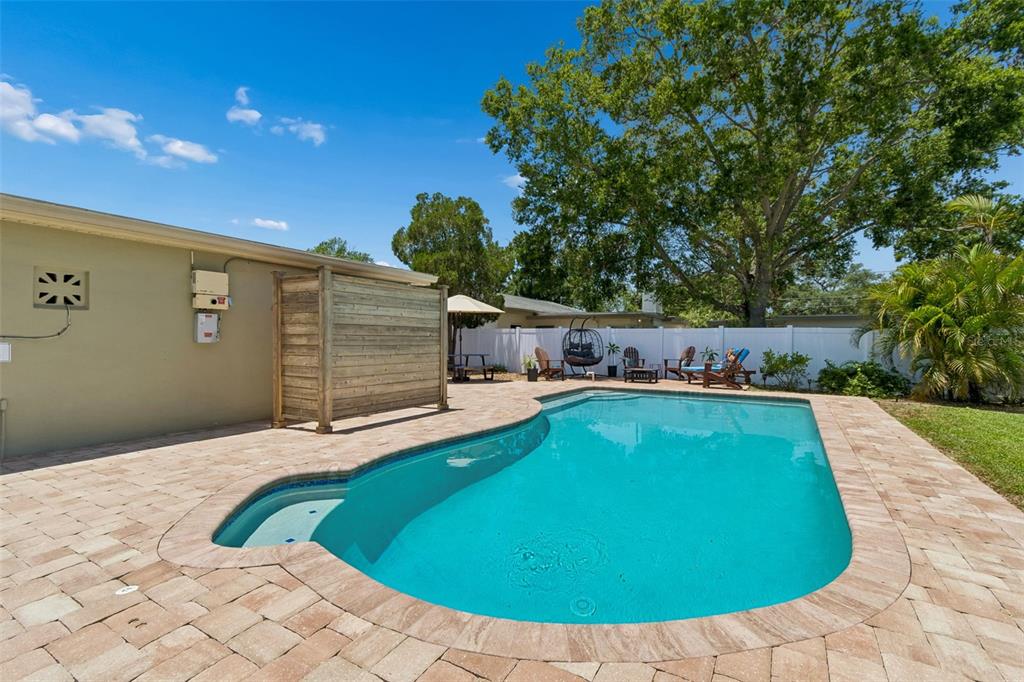 A single-story house with a paved driveway and a white vinyl privacy fence — 604 7TH AVENUE SW, LARGO, FL
