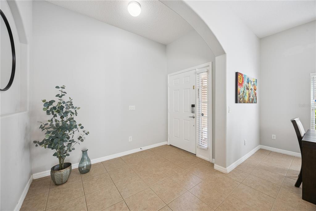 A dining room features a dark wood table, six chairs, and three windows with blinds — 11625 GREAT COMMISSION WAY, ORLANDO, FL