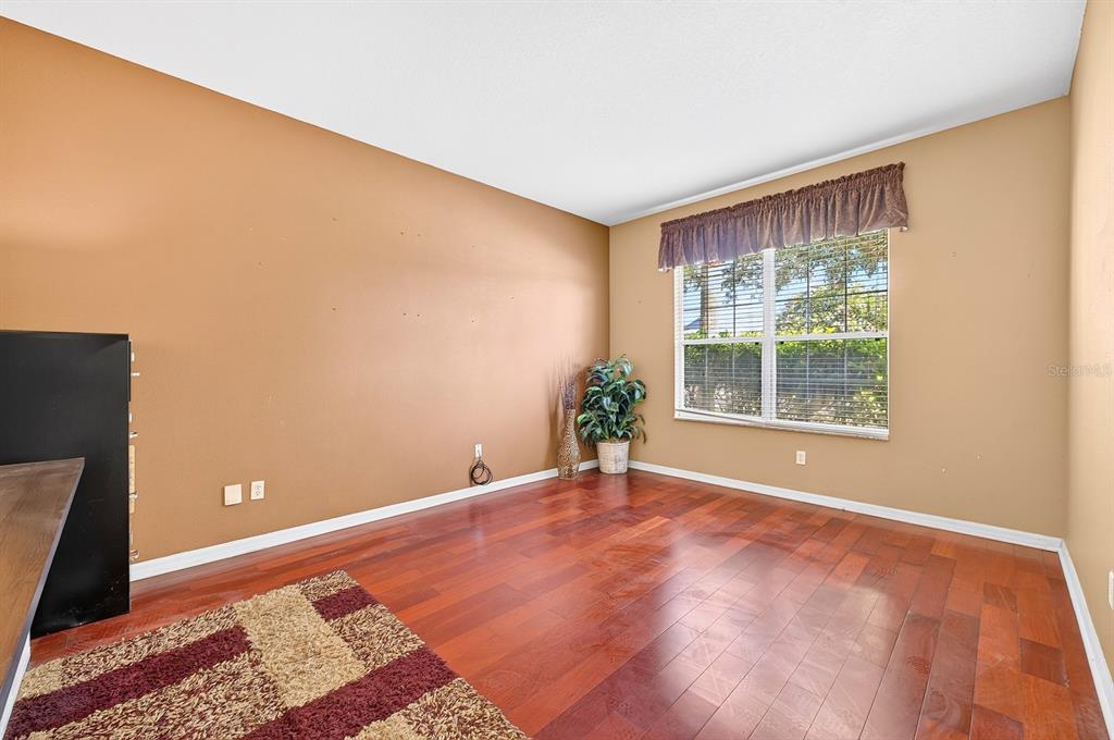 A kitchen with oak cabinets, stainless steel appliances, a center island, and tile flooring — 13537 KITTY FORK ROAD, ORLANDO, FL