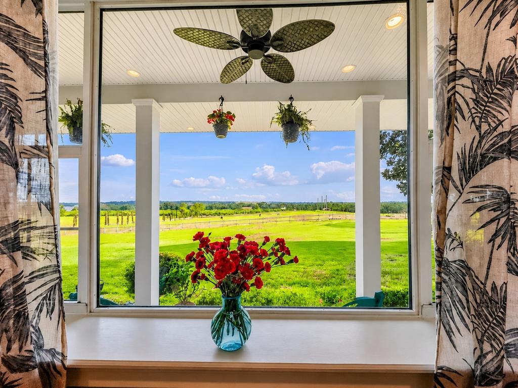 A two-story house with a front porch sits on a large, grassy rural lot — 915 N CROOKED LAKE DRIVE, BABSON PARK, FL