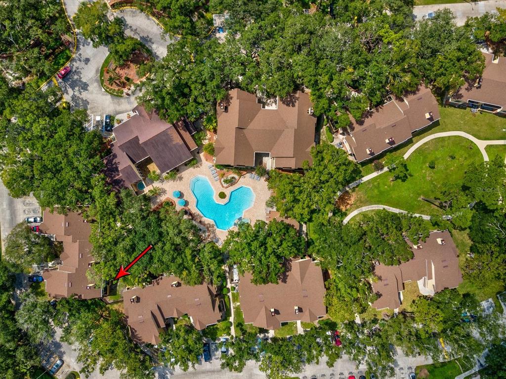 An aerial view shows a residential complex with a central swimming pool and surrounding buildings — 8653 MALLARD RESERVE DRIVE UNIT 103, TAMPA, FL