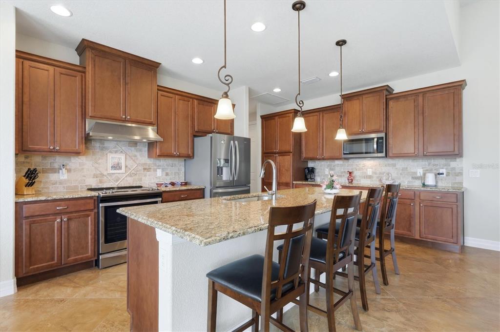 A spacious living room with a tray ceiling opens to a kitchen and a screened patio — 60 HARNESS ROAD, PLACIDA, FL