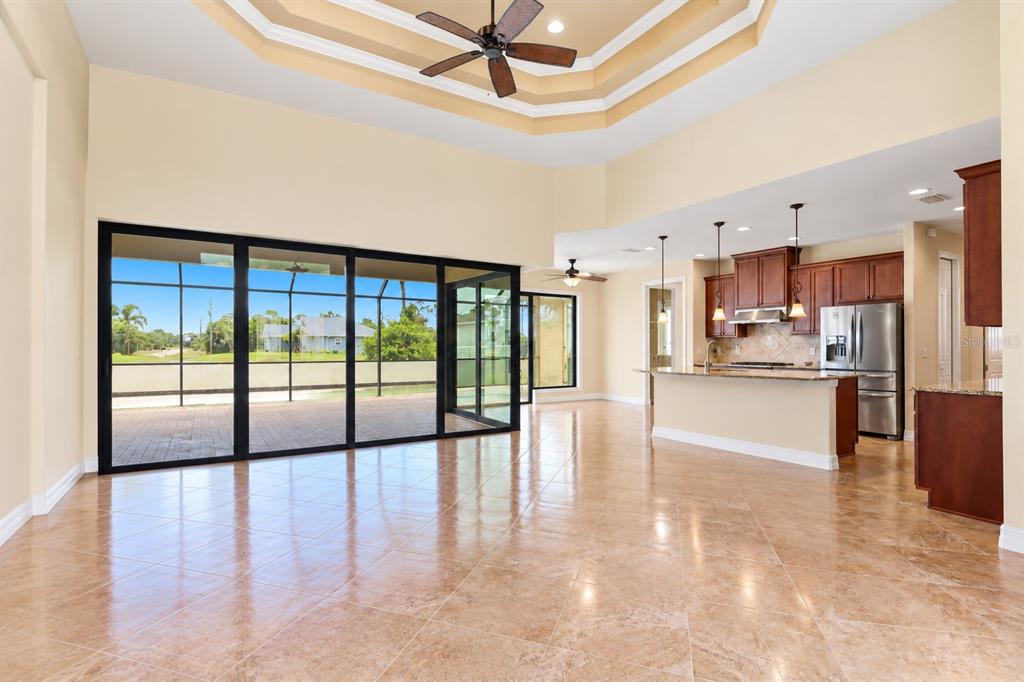 A dining area features a wooden table, ornate chairs, tile flooring, and sliding glass doors — 60 HARNESS ROAD, PLACIDA, FL