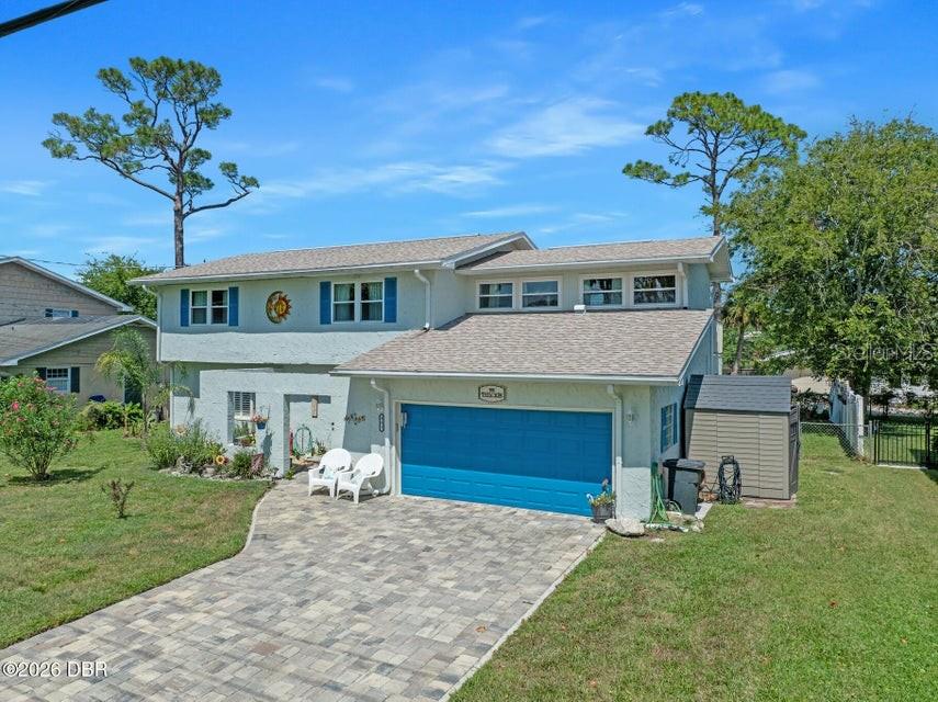 A two-story house with a blue garage door and a paved driveway — 461 ANDREWS STREET, ORMOND BEACH, FL