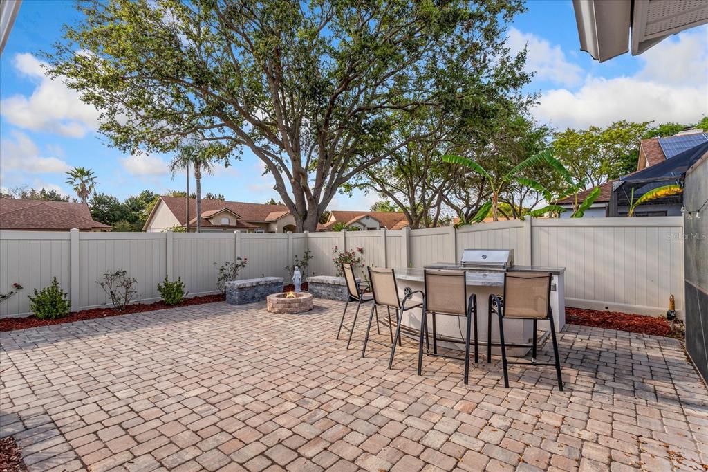 An entryway features a wooden front door, tiled flooring, a high ceiling, and louvered closet doors — 2821 LONE FEATHER DRIVE, ORLANDO, FL