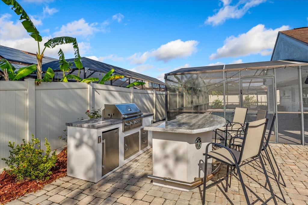 A dining area with hardwood floors and a foyer with tile flooring and a door — 2821 LONE FEATHER DRIVE, ORLANDO, FL