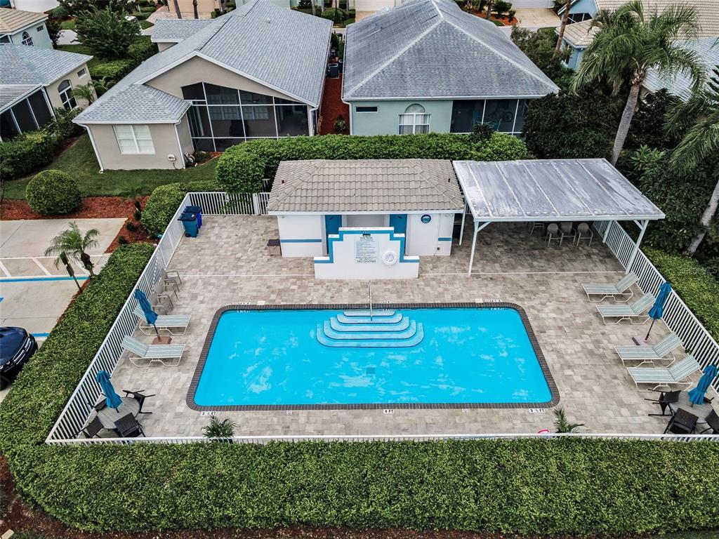 A single-story house with a tan exterior, a two-car garage, and a brick paver driveway — 9310 SOUCHAK DRIVE, TRINITY, FL