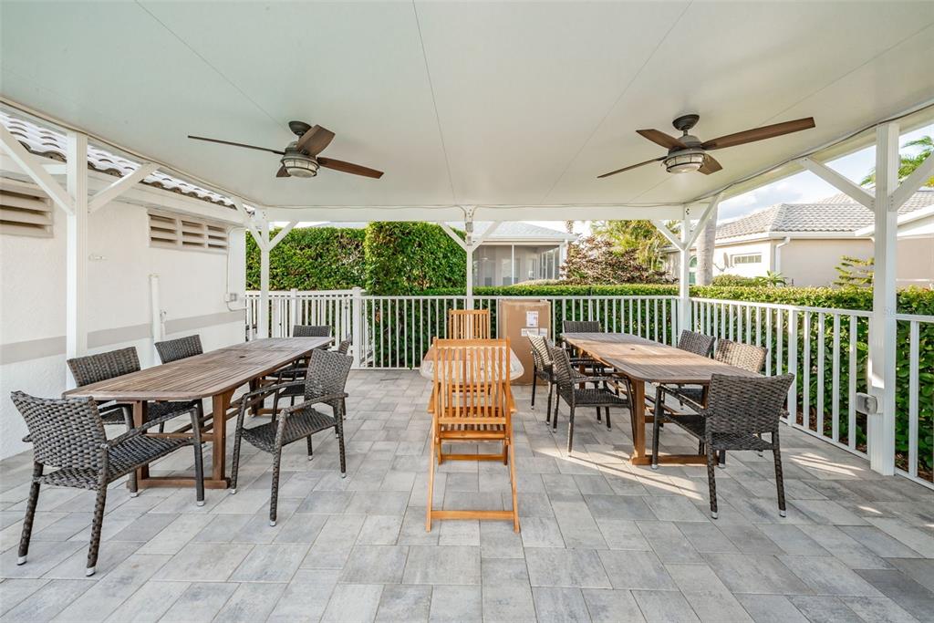 The exterior of a beige house features a brick walkway leading to a front door — 9310 SOUCHAK DRIVE, TRINITY, FL