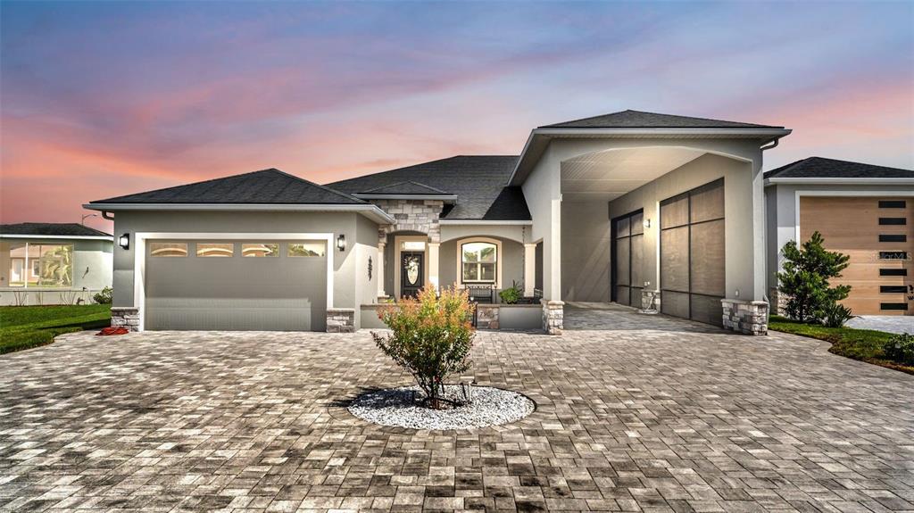 A single-story house with a paved driveway, a two-car garage, and a covered entryway — 790 TEABERRY TRAIL, POLK CITY, FL