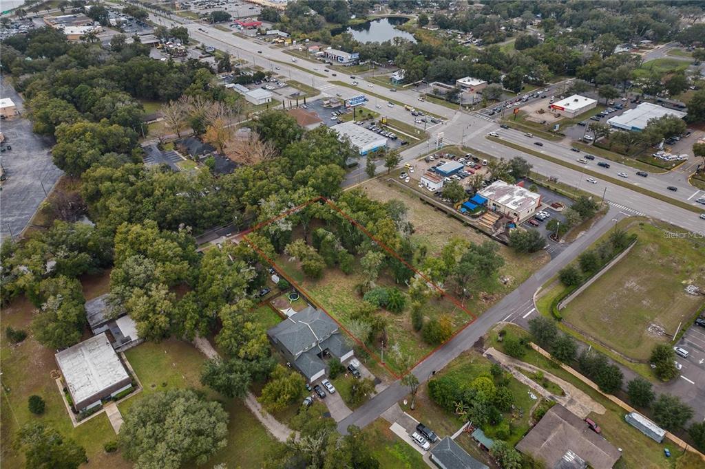 An aerial view shows a residential lot outlined in red next to a two-story house — SAND AVENUE, APOPKA, FL
