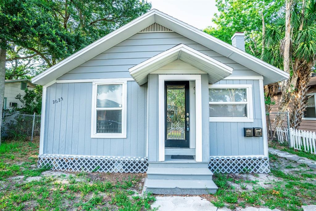 A light blue, single-story house with a gabled roof, a front porch, and lattice skirting — 2625 4TH AVENUE S, ST PETERSBURG, FL