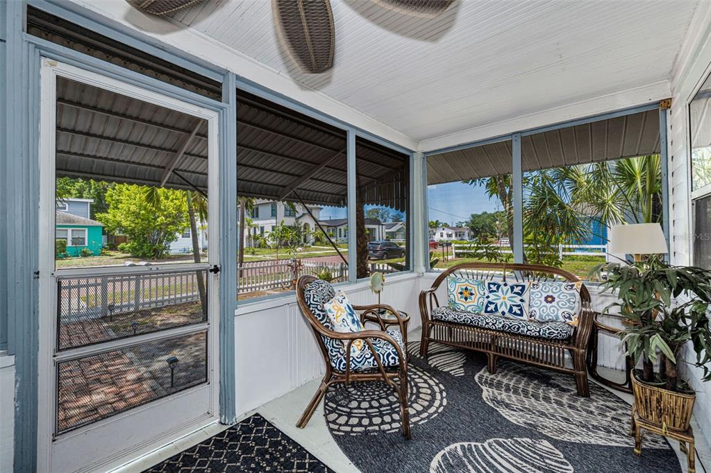 A white cottage with a brick walkway and a white picket fence in the front yard — 3829 2ND AVENUE N, ST PETERSBURG, FL