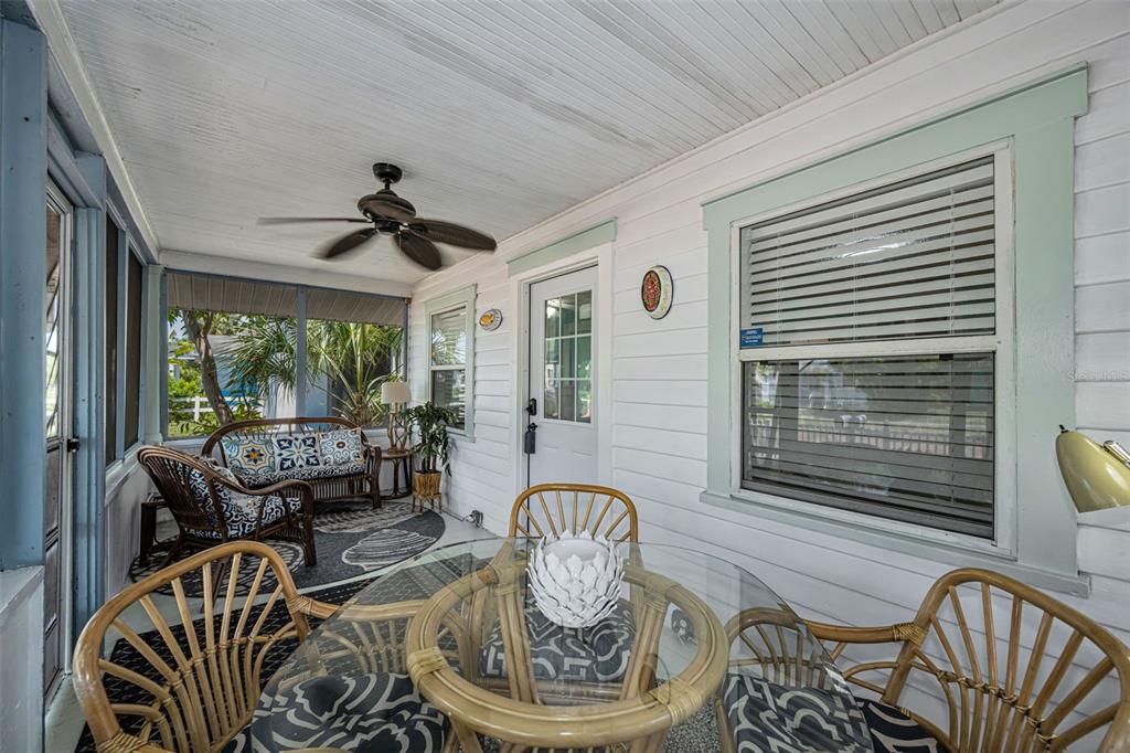 A white cottage with a screened porch, brick chimney, and palm trees in the yard — 3829 2ND AVENUE N, ST PETERSBURG, FL