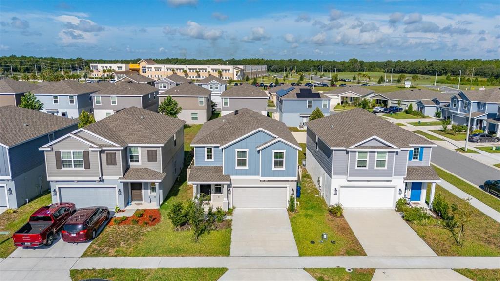 A kitchen features black cabinets, white countertops, a center island, and stainless steel appliances — 1334 DIEGO TERRACE UNIT A, WINTER HAVEN, FL