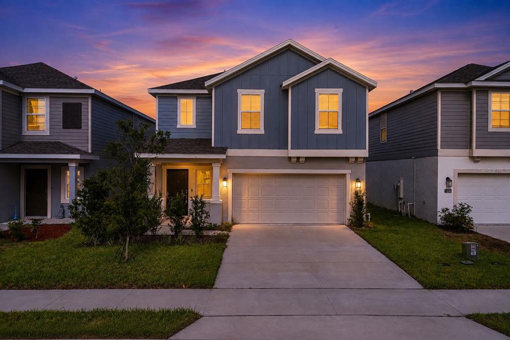 A bathroom features a double vanity with dark cabinets, quartz countertops, and an adjacent walk-in closet — 1334 DIEGO TERRACE UNIT A, WINTER HAVEN, FL