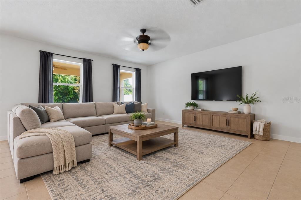 A two-story suburban house with a beige stucco exterior, a garage, and a front lawn — 21439 SOUTHERN CHARM DRIVE, LAND O LAKES, FL