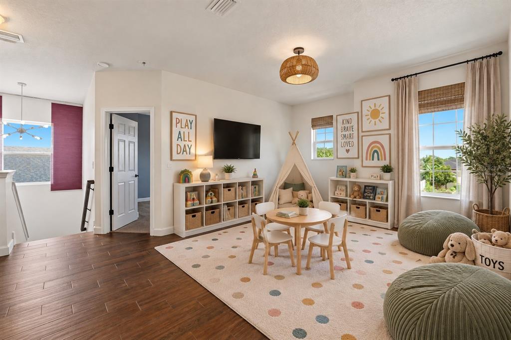 A two-story suburban house with a beige stucco exterior, a two-car garage, and a driveway — 21439 SOUTHERN CHARM DRIVE, LAND O LAKES, FL