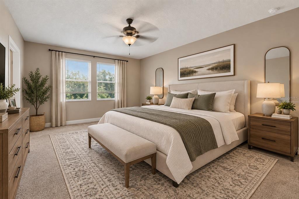 A two-story suburban house with a two-car garage, a front lawn, and flowering trees — 21439 SOUTHERN CHARM DRIVE, LAND O LAKES, FL