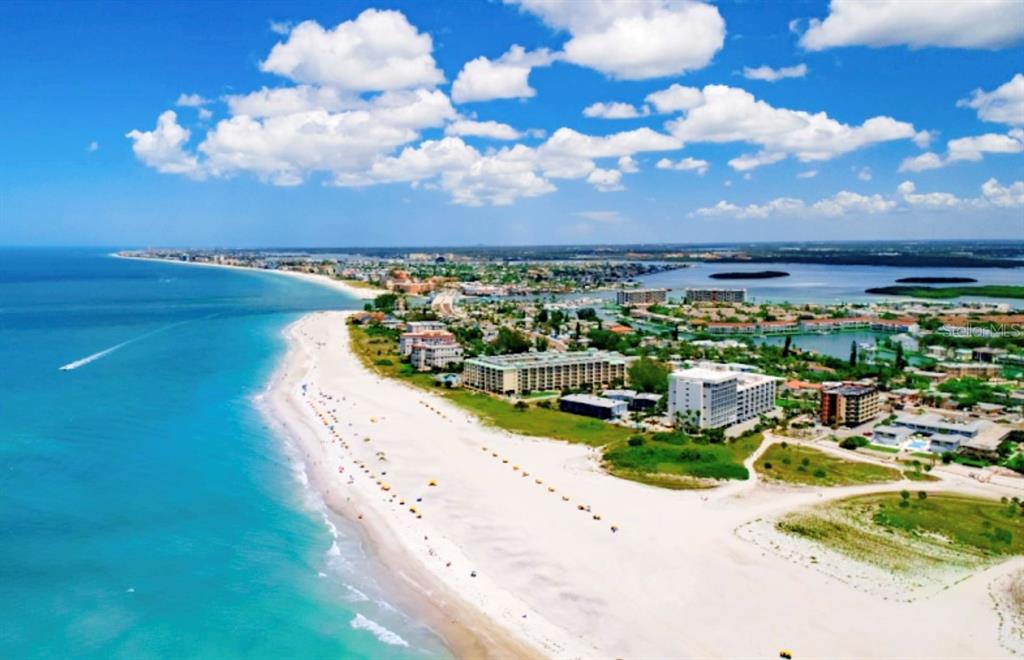 Aerial view of a white sand beach along a coastline with hotels and residential buildings — 11965 GULF BOULEVARD, ST PETERSBURG, FL