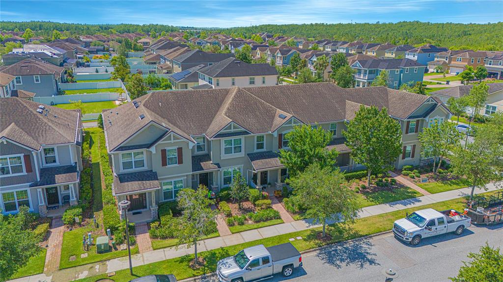 An aerial view shows a multi-unit townhouse building with gray siding and brown shingled roofs — 10520 BURROWS STREET, ORLANDO, FL