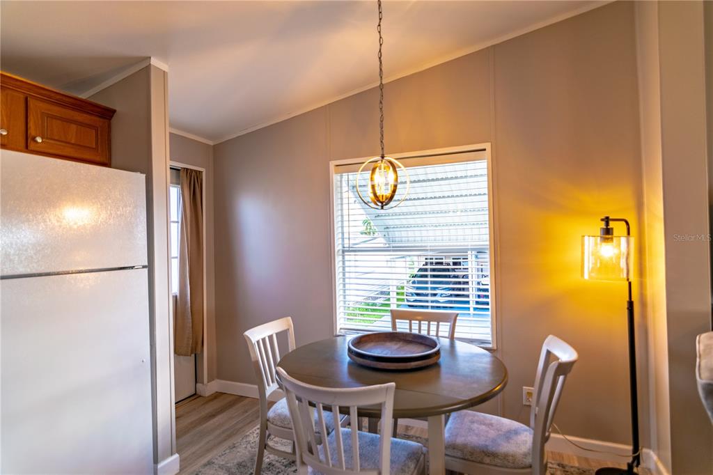 A kitchen features wood cabinets, white appliances, a double sink, and light-colored countertops — 8320 RIVERSIDE DRIVE UNIT 51B, PUNTA GORDA, FL