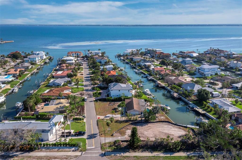An aerial view of a waterfront residential neighborhood with canals, docks, and houses — 500 OUTRIGGER LANE, LONGBOAT KEY, FL