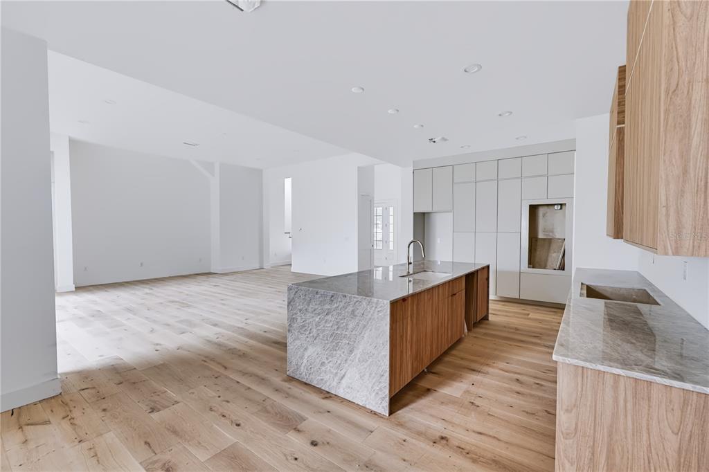 A digital rendering of a two-story white farmhouse with a wraparound porch and attached garage — 1122 DINGENS AVENUE, GOTHA, FL