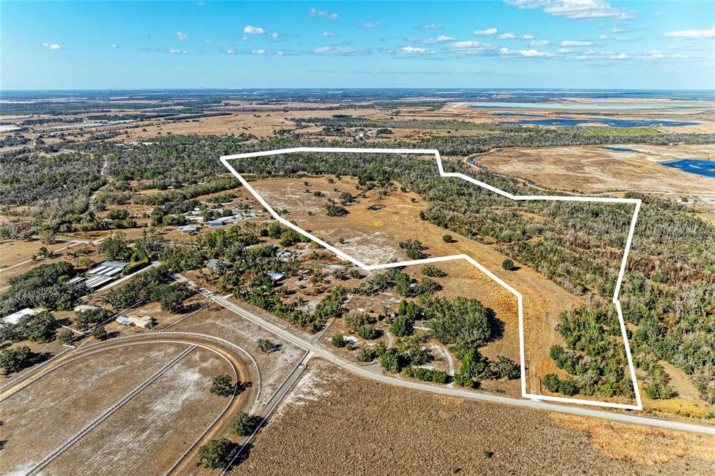 An aerial view shows a large, irregularly shaped plot of land outlined in white — 33100 & 33070 TAYLOR GRADE ROAD, PARRISH, FL