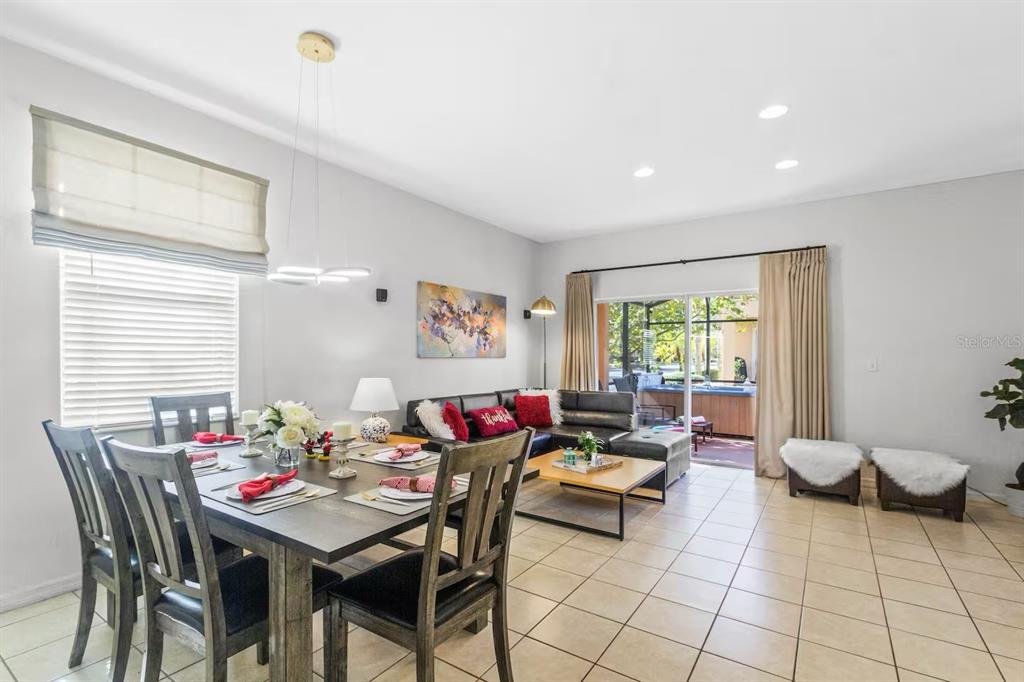 A hot tub sits on a screened-in patio overlooking a residential neighborhood — 2700 CAMARO DRIVE, KISSIMMEE, FL