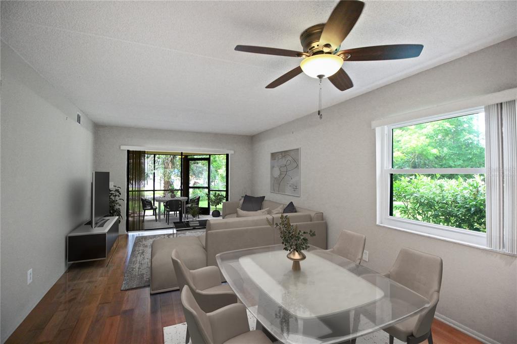 A living and dining area features wood flooring, a ceiling fan, and a screened-in patio — 135 WOODLAKE WYNDE UNIT 135, OLDSMAR, FL
