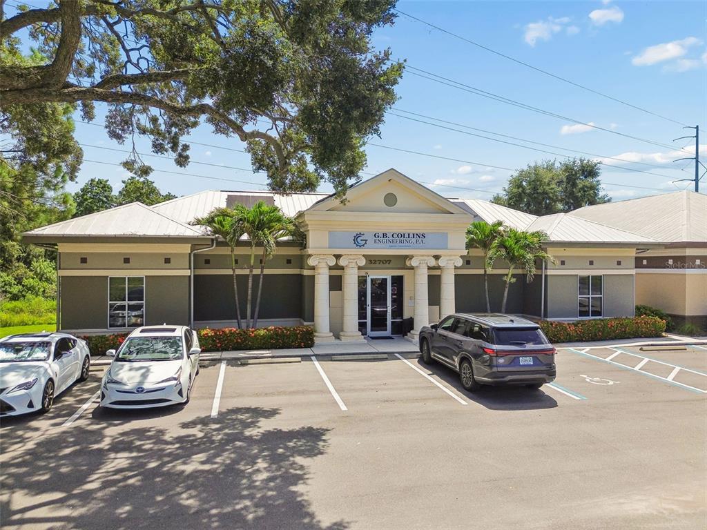 This is a floor plan of an office space with multiple rooms and wooden flooring — 32707 US HIGHWAY 19 N, PALM HARBOR, FL