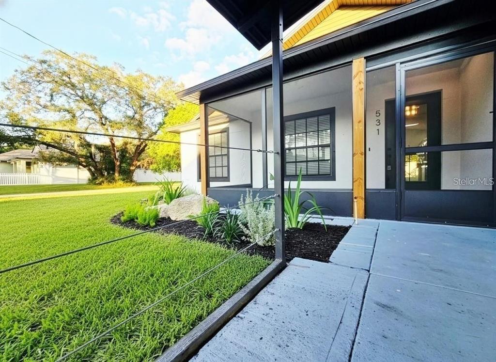 A screened-in porch with a concrete floor and a dark frame overlooks a grassy yard — 531 1ST AVENUE, ALTAMONTE SPRINGS, FL