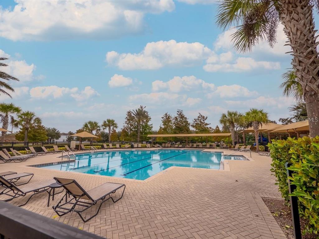 A two-story house with a covered front porch, stone pillars, and an American flag — 7537 BROFIELD AVENUE, WINDERMERE, FL