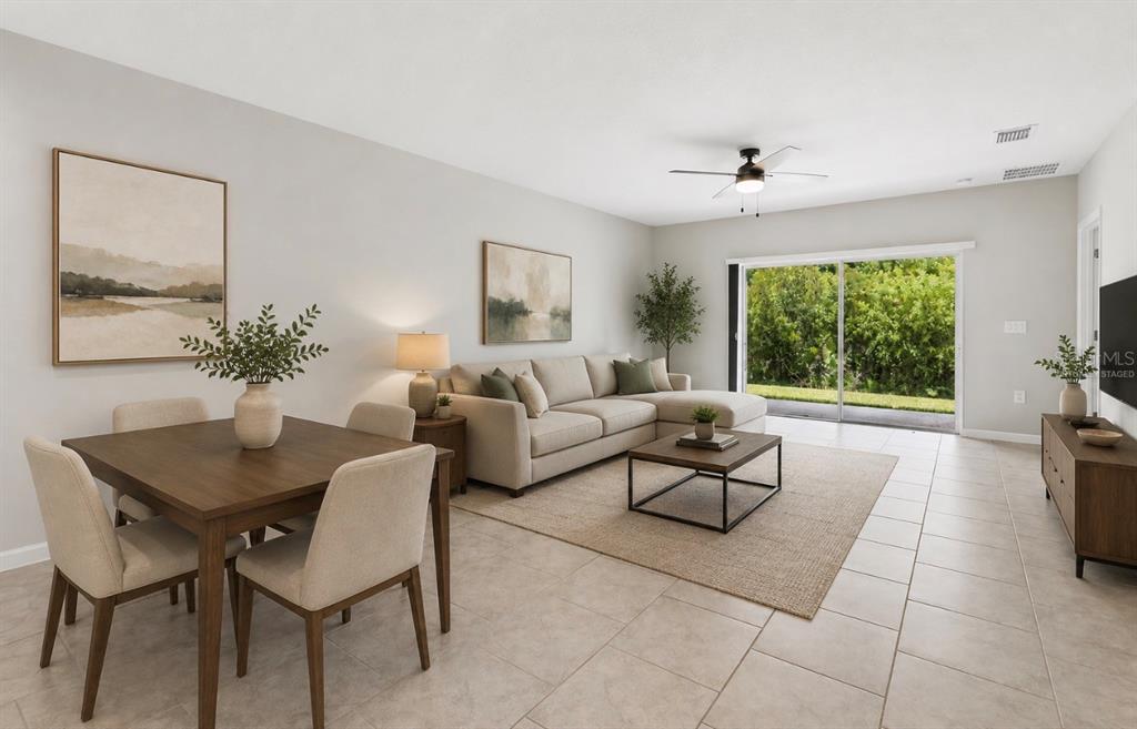 A black front door is set into a gray stucco exterior wall with a doormat — 18307 TURNING LEAF CIRCLE, LAND O LAKES, FL