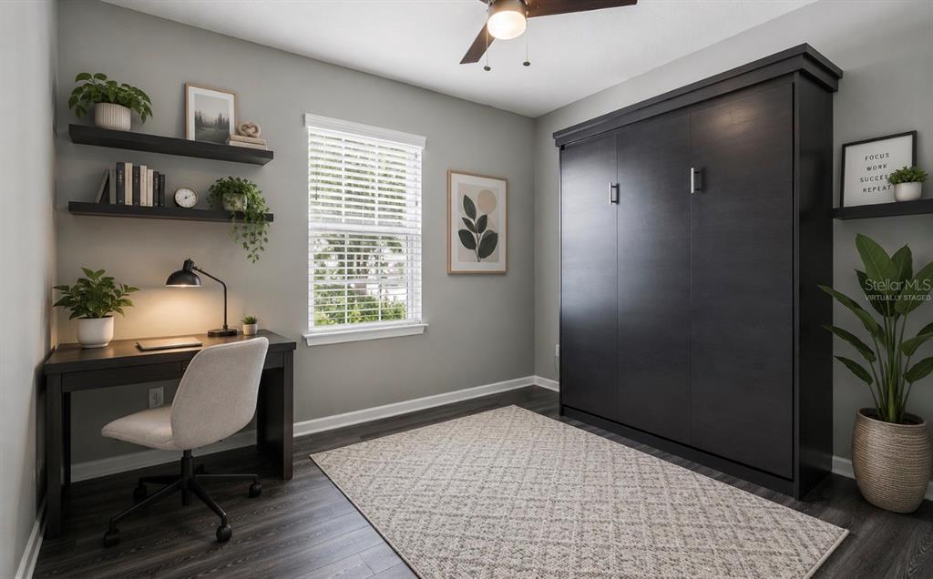 A kitchen features white cabinets, granite countertops, stainless steel appliances, and a black faucet — 18307 TURNING LEAF CIRCLE, LAND O LAKES, FL