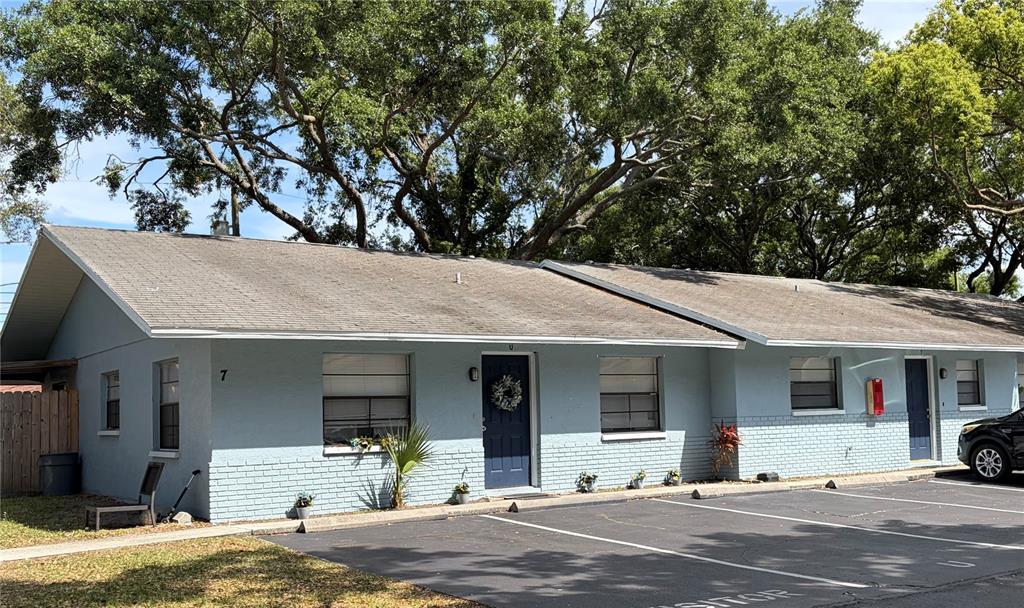 A light blue single-story apartment building with a parking lot in front — 950 BELTREES STREET, DUNEDIN, FL