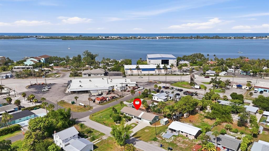 An aerial view shows a residential house with a red location pin near a bay — 898 S BROADWAY, ENGLEWOOD, FL