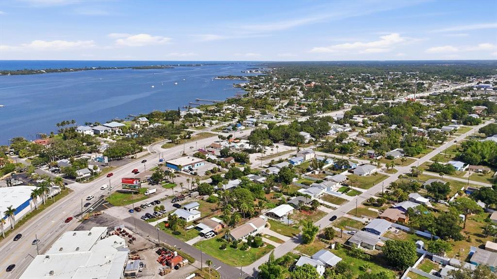 An aerial view shows a coastal town with houses, roads, and a large body of water — 898 S BROADWAY, ENGLEWOOD, FL
