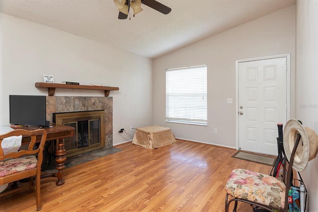 A two-story apartment building features a central staircase leading to upper-level screened balconies — 507 NORTHLAKE DRIVE UNIT 507, SANFORD, FL