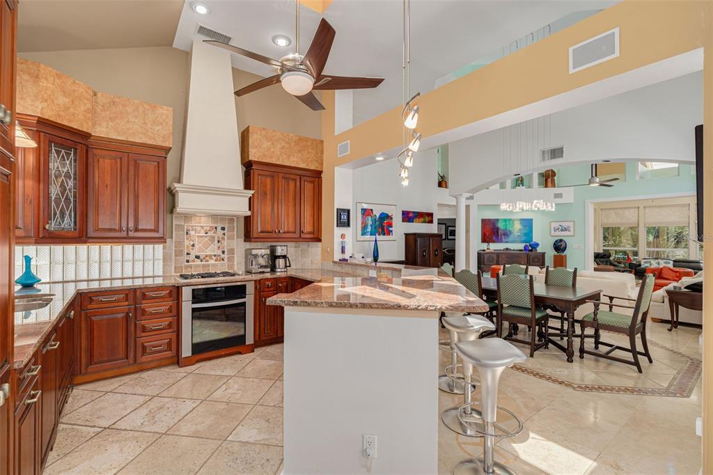 A dining room with a wooden table and chairs sits adjacent to an open kitchen — 2613 59TH STREET S, GULFPORT, FL