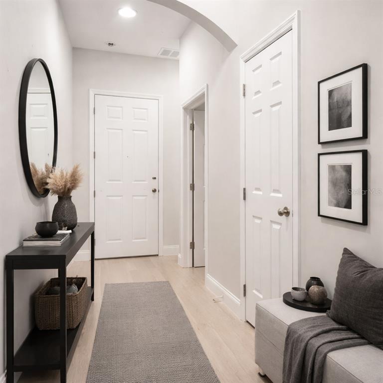 A modern kitchen features gray cabinets, stainless steel appliances, and a white-topped center island — 827 DENNIS AVENUE, ORLANDO, FL