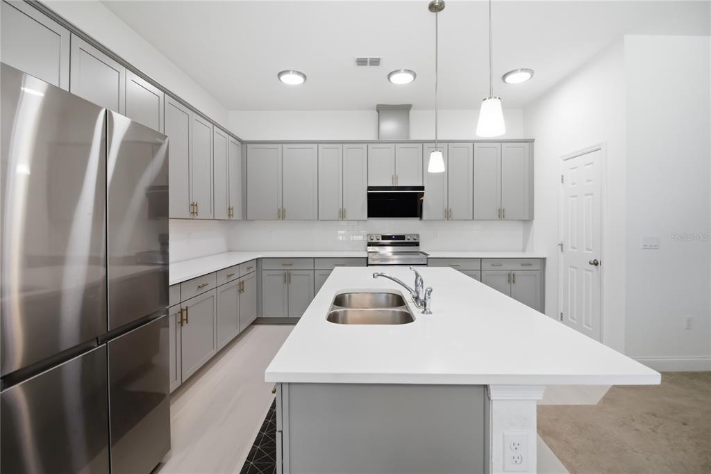A dining room features a black table, light gray chairs, and a large sliding glass door — 827 DENNIS AVENUE, ORLANDO, FL